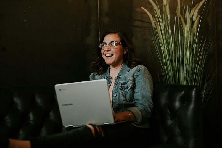 Woman working on laptop with focused expression